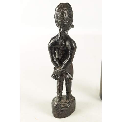 921 - A 20TH CENTURY AFRICAN CARVED EBONY FIGURE OF A SLAVE (33cm high)