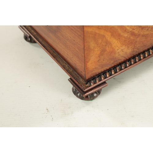 929 - A WILLIAM IV FIGURED MAHOGANY TEA CADDY with moulded edge and bun feet; having a fully fitted interi... 