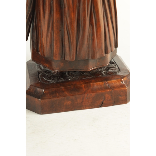 930 - A FINE PAIR OF 19TH CENTURY CARVED WALNUT BLACK FOREST TABACO JARS depicting a lady and gentleman, h... 