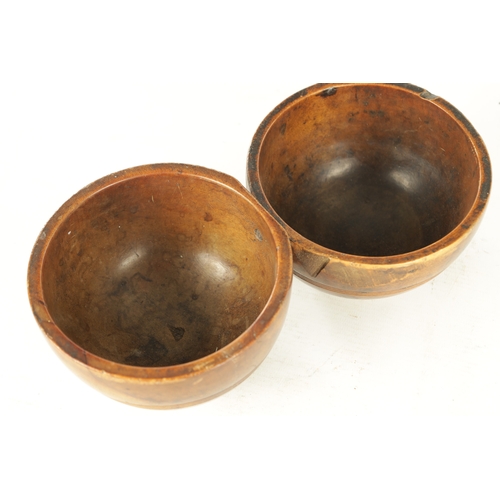 938 - A JOINED PAIR OF 19TH CENTURY WELSH TREEN CAWL BOWLS, with carved banding around the bodies and rais... 