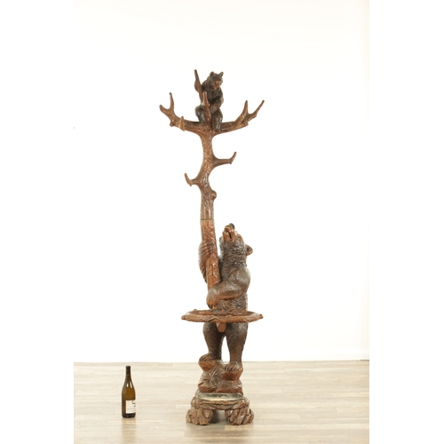 951 - A 19TH CENTURY CARVED LINDEN WOOD BLACK FOREST BEAR AND CUB HALL STAND depicting a carved standing b... 