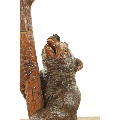 951 - A 19TH CENTURY CARVED LINDEN WOOD BLACK FOREST BEAR AND CUB HALL STAND depicting a carved standing b... 