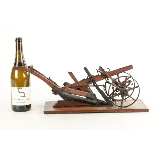 955 - A GOOD 19TH CENTURY OAK AND STEEL MODEL OF A HAND HELD PLOUGH finely made with spoked wheels and adj... 