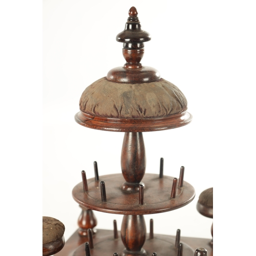 956 - A 19TH CENTURY ROSEWOOD BOBBIN STAND having a tiered stand with a domed pin cushion, a base with a s... 