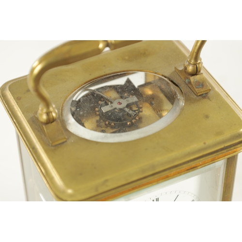 1007 - A LATE 19TH CENTURY BRASS STRIKING CARRIAGE CLOCK with a white enamel dial having a Roman chapter ri... 