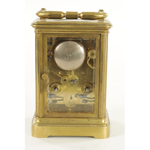 1007 - A LATE 19TH CENTURY BRASS STRIKING CARRIAGE CLOCK with a white enamel dial having a Roman chapter ri... 