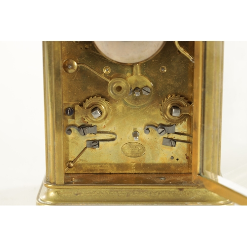 1007 - A LATE 19TH CENTURY BRASS STRIKING CARRIAGE CLOCK with a white enamel dial having a Roman chapter ri... 