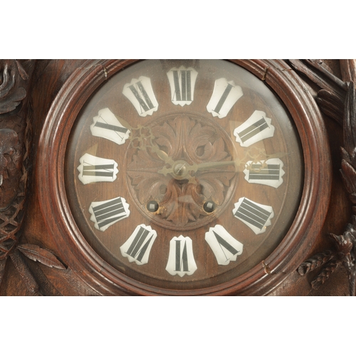 1015 - A 19TH CENTURY BLACK FOREST CARVED OAK HANGING WALL CLOCK with scrolled case having a boar's head su... 