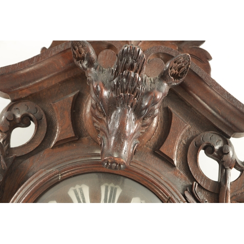 1015 - A 19TH CENTURY BLACK FOREST CARVED OAK HANGING WALL CLOCK with scrolled case having a boar's head su... 