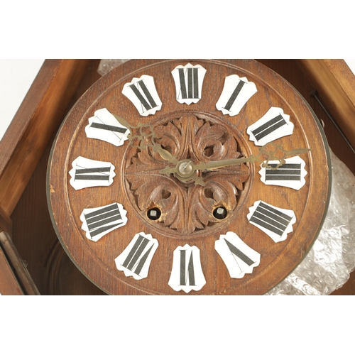 1015 - A 19TH CENTURY BLACK FOREST CARVED OAK HANGING WALL CLOCK with scrolled case having a boar's head su... 