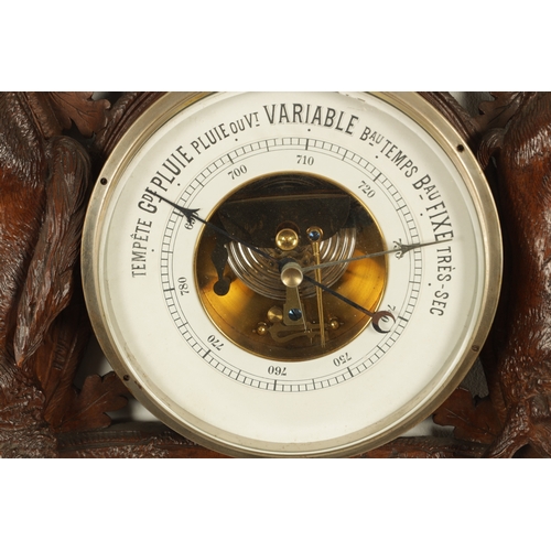 1028 - A LATE 19TH CENTURY BLACK FOREST CARVED BAROMETER, the case surmounted by an eagle above a carved oa... 