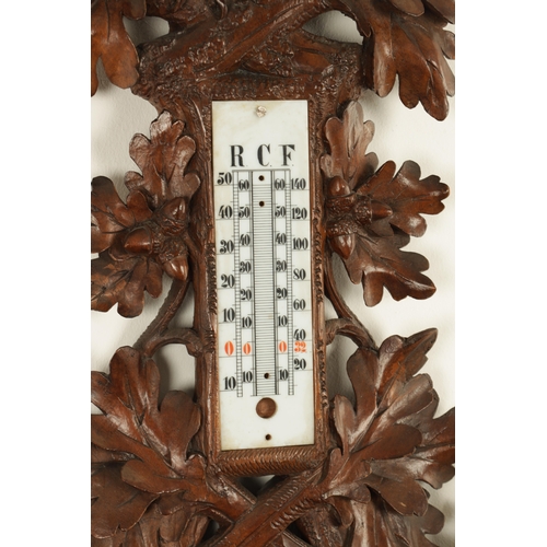 1028 - A LATE 19TH CENTURY BLACK FOREST CARVED BAROMETER, the case surmounted by an eagle above a carved oa... 