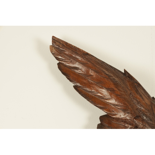 1028 - A LATE 19TH CENTURY BLACK FOREST CARVED BAROMETER, the case surmounted by an eagle above a carved oa... 