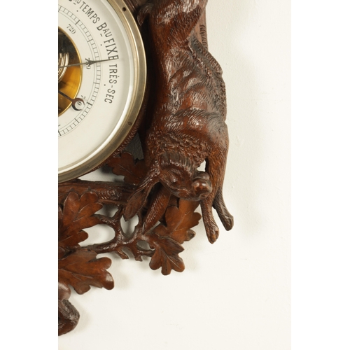 1028 - A LATE 19TH CENTURY BLACK FOREST CARVED BAROMETER, the case surmounted by an eagle above a carved oa... 