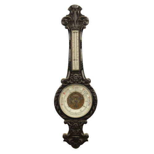 1133 - A LARGE LATE 19TH CENTURY CARVED OAK ANEROID BAROMETER with calibrated porcelain thermometer and bar... 