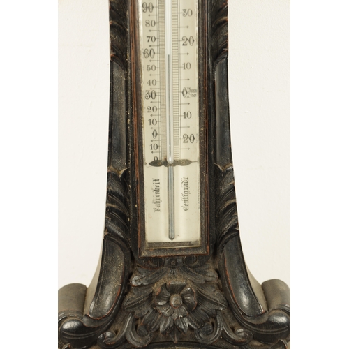 1133 - A LARGE LATE 19TH CENTURY CARVED OAK ANEROID BAROMETER with calibrated porcelain thermometer and bar... 