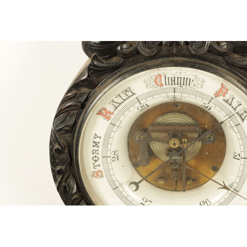 1133 - A LARGE LATE 19TH CENTURY CARVED OAK ANEROID BAROMETER with calibrated porcelain thermometer and bar... 