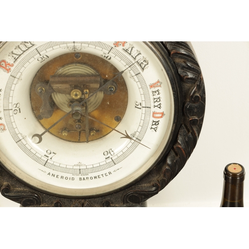 1133 - A LARGE LATE 19TH CENTURY CARVED OAK ANEROID BAROMETER with calibrated porcelain thermometer and bar... 