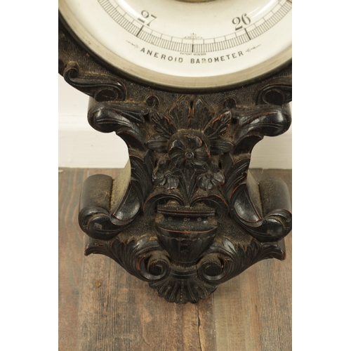 1133 - A LARGE LATE 19TH CENTURY CARVED OAK ANEROID BAROMETER with calibrated porcelain thermometer and bar... 