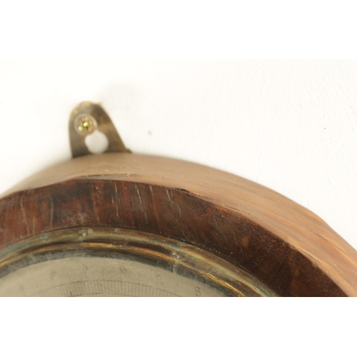 1182 - A FIGURED MAHOGANY CLOCK BAROMETER SIGNED NEGRETTI & ZAMBRA, the silvered calibrated barometer dial ... 