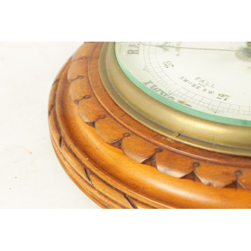 1204 - A LATE 19TH CENTURY ANEROID BAROMETER having a carved walnut surround with cast brass bezel enclosin... 