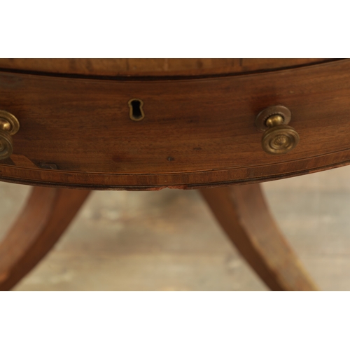 1211 - A REGENCY FIGURED MAHOGANY DRUM TABLE with a segmented inlaid top above a bank of drawers to the fri... 