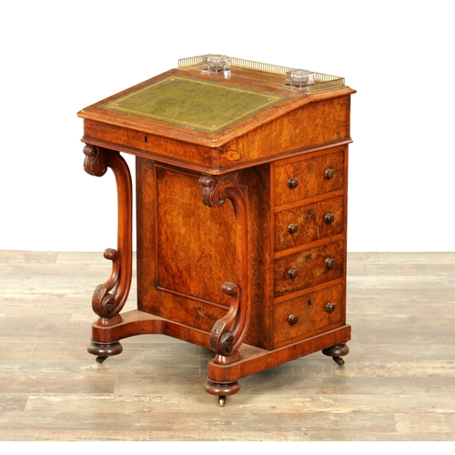 1214 - A VICTORIAN BURR WALNUT DAVENPORT with leathered writing surface scrolled carved columns and side dr... 