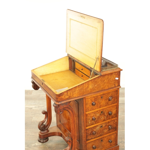 1214 - A VICTORIAN BURR WALNUT DAVENPORT with leathered writing surface scrolled carved columns and side dr... 