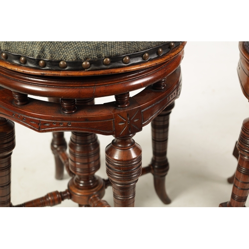 1217 - TWO 19TH CENTURY CIRCULAR WALNUT REVOLVING PIANO STOOLS on turned splayed legs joined by under stret... 