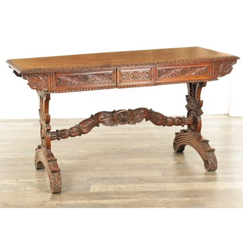 1218 - A 19TH CENTURY ANGLO INDIAN CARVED HARDWOOD LIBRARY TABLE with gadrooned leaf carved edge above frie... 