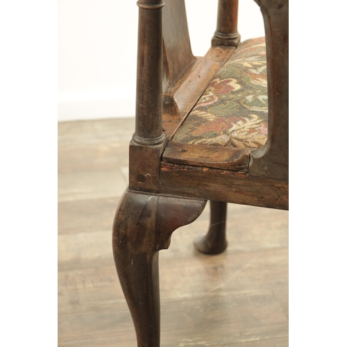 1221 - AN EARLY 18TH CENTURY WALNUT CORNER CHAIR with shaped back and tapering back splats, above a tapestr... 