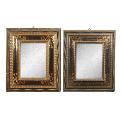 1222 - A MATCHED PAIR OF 18TH CENTURY CONTINENTAL EBONISED AND GILT PAINTED HANGING MIRRORS with cushion fr... 