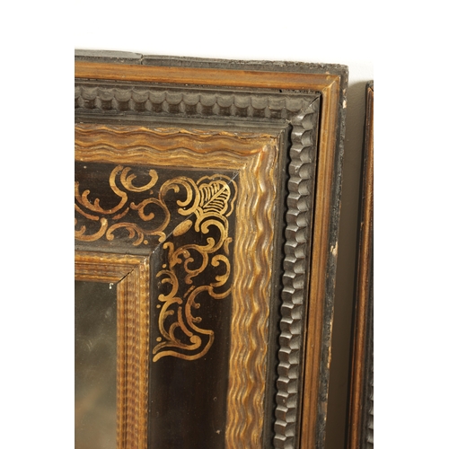 1222 - A MATCHED PAIR OF 18TH CENTURY CONTINENTAL EBONISED AND GILT PAINTED HANGING MIRRORS with cushion fr... 