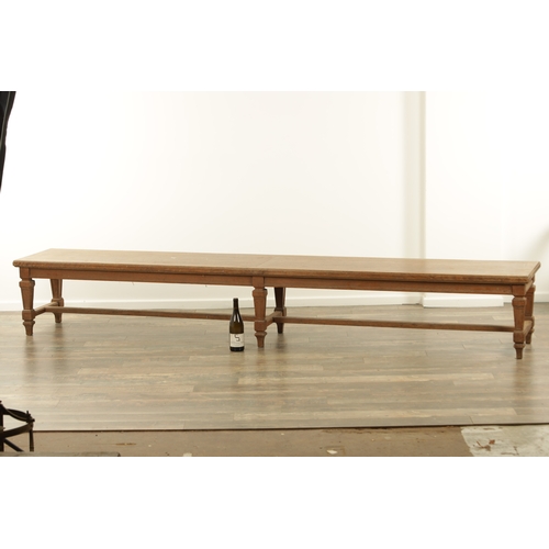 1223 - A PAIR OF LARGE OAK HALL BENCHES IN THE MANNER OF HOLLAND AND SON raised on square tapering legs joi... 