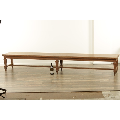 1223 - A PAIR OF LARGE OAK HALL BENCHES IN THE MANNER OF HOLLAND AND SON raised on square tapering legs joi... 