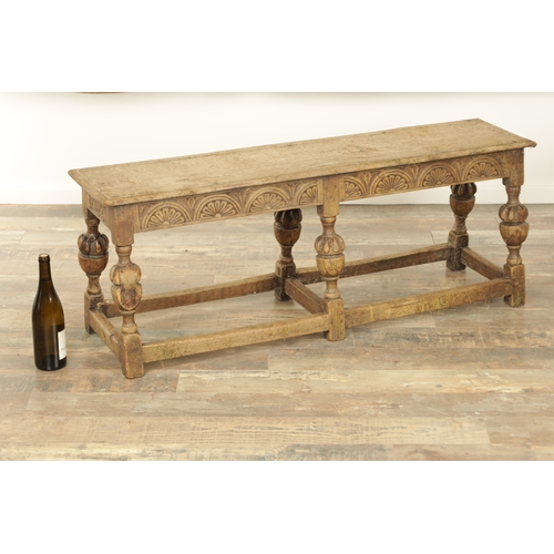 1227 - A 17TH CENTURY STYLE OAK LONG JOINT STOOL with an arcaded carved frieze above bulbous turned legs jo... 