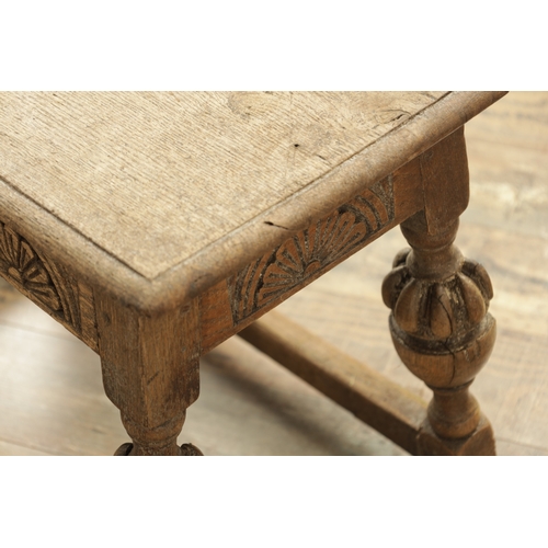 1227 - A 17TH CENTURY STYLE OAK LONG JOINT STOOL with an arcaded carved frieze above bulbous turned legs jo... 