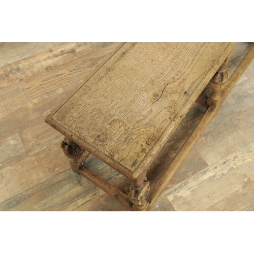 1227 - A 17TH CENTURY STYLE OAK LONG JOINT STOOL with an arcaded carved frieze above bulbous turned legs jo... 