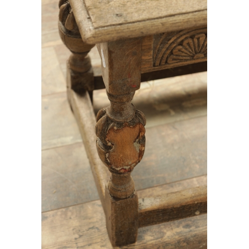 1227 - A 17TH CENTURY STYLE OAK LONG JOINT STOOL with an arcaded carved frieze above bulbous turned legs jo... 