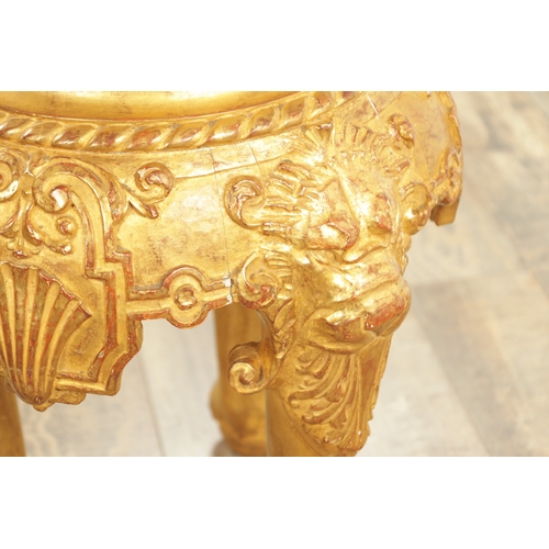 1234 - AN 18TH CENTURY CARVED GILTWOOD JARDINIERE STAND with lion head and shell carved frieze raised on pa... 