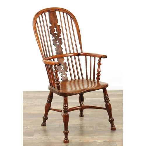 1247 - AN EARLY 19TH CENTURY NOTTINGHAMSHIRE YEW WOOD HIGH BACK WINDSOR CHAIR with hooped back and shaped p... 