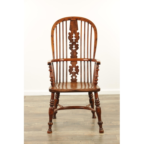 1247 - AN EARLY 19TH CENTURY NOTTINGHAMSHIRE YEW WOOD HIGH BACK WINDSOR CHAIR with hooped back and shaped p... 