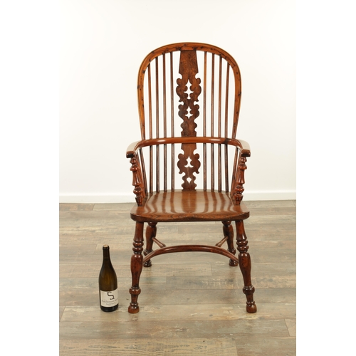 1247 - AN EARLY 19TH CENTURY NOTTINGHAMSHIRE YEW WOOD HIGH BACK WINDSOR CHAIR with hooped back and shaped p... 