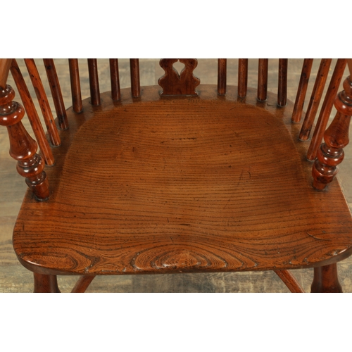 1247 - AN EARLY 19TH CENTURY NOTTINGHAMSHIRE YEW WOOD HIGH BACK WINDSOR CHAIR with hooped back and shaped p... 