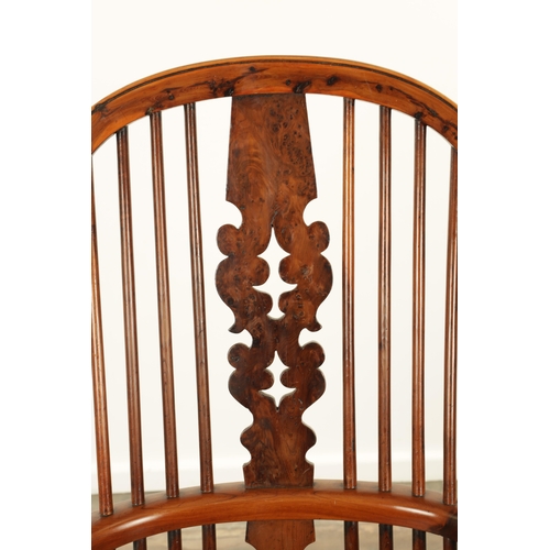 1247 - AN EARLY 19TH CENTURY NOTTINGHAMSHIRE YEW WOOD HIGH BACK WINDSOR CHAIR with hooped back and shaped p... 