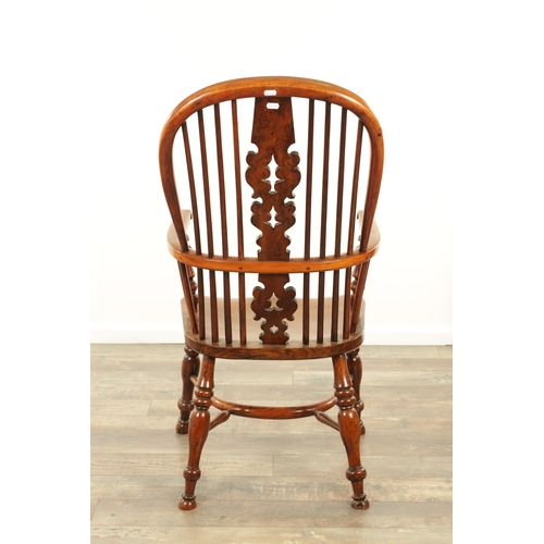 1247 - AN EARLY 19TH CENTURY NOTTINGHAMSHIRE YEW WOOD HIGH BACK WINDSOR CHAIR with hooped back and shaped p... 