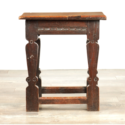 1253 - A 17TH CENTURY STYLE JOINED OAK JOINT STOOL with plank top and chip-carved frieze, raised on silhoue... 