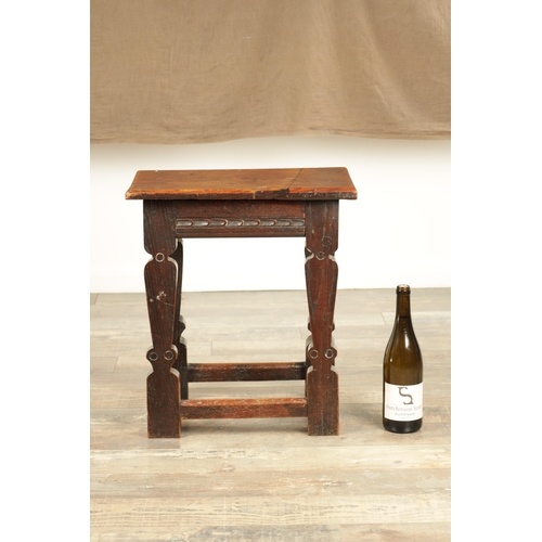 1253 - A 17TH CENTURY STYLE JOINED OAK JOINT STOOL with plank top and chip-carved frieze, raised on silhoue... 