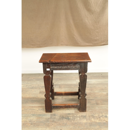 1253 - A 17TH CENTURY STYLE JOINED OAK JOINT STOOL with plank top and chip-carved frieze, raised on silhoue... 