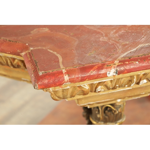 1256 - A STYLISH PAIR OF CARVED GILTWOOD AND SCUMBLED MARBLE CONSOLE TABLES having outset corners raised on... 